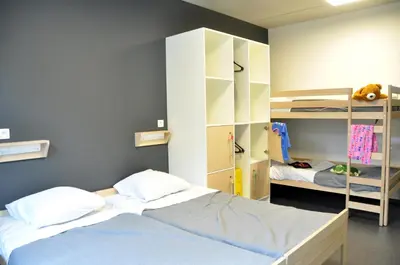 a bedroom with a bed and a bunk room at Hostel H in Hasselt