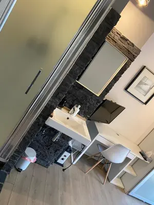 an overhead view of a bathroom with a sink and a desk at Studio Peralta in Liège
