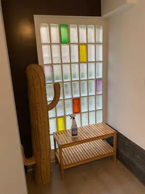 a room with a bench and a window with colored glass at Studio Peralta in Liège
