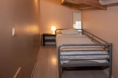 a small room with two bunk beds in it at DE SMISHOEVE met kinderpret, dieren en wellness in Heers