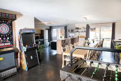 a room with a table and a dart board at DE SMISHOEVE met kinderpret, dieren en wellness in Heers