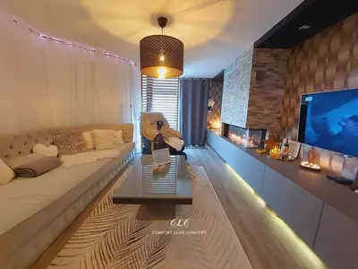 a living room with a couch and a tv at La Suite in La Calamine
