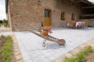 a bench with a flower pot on it in a patio at Vakantiewoning Venderhof in Maaseik