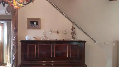 a stairway with a wooden dresser in a room at Vakantiewoning Venderhof in Maaseik