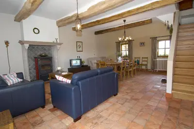 a living room with two blue couches and a table at Vakantiewoning Venderhof in Maaseik