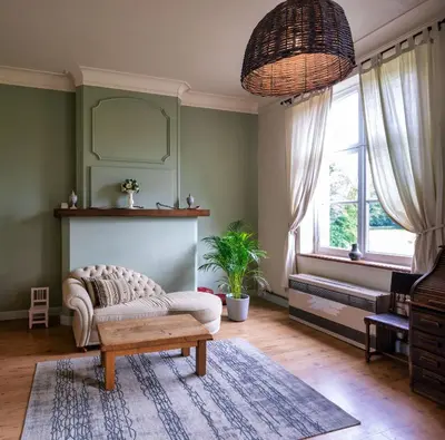 a living room with a couch and a table at Kasteel Nieuwenhoven in Sint-Truiden