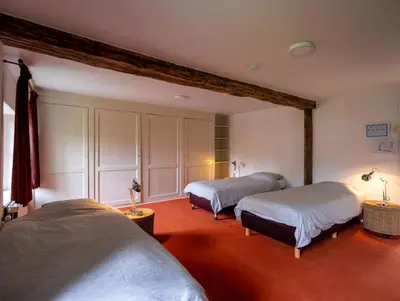 a bedroom with two beds in a room at Kasteel Nieuwenhoven in Sint-Truiden