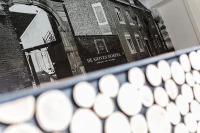 a close up of a keyboard with a reflection of a building at De Sjeiven Dorpel in Maaseik