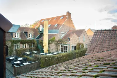 a group of houses with roofs in a city at De Sjeiven Dorpel in Maaseik