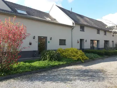 a white house with a garden in front of it at De Aventurijn in Riemst