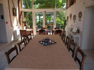 a dining room with a table and chairs at De Aventurijn in Riemst