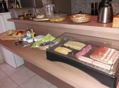 a counter with a drawer filled with cheese and meats at De Aventurijn in Riemst