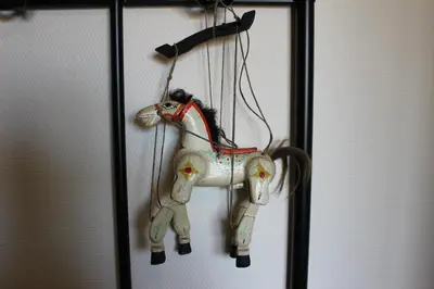 a toy horse is hanging on a wall at Villa Kakelbont Borgloon in Borgloon