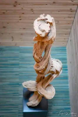 a wooden sculpture of a tree on a table at Sleepwood Hotel in Eupen