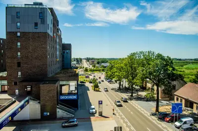 a view of a city street with cars on the road at Hotel Stayen in Sint-Truiden
