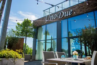 a restaurant with tables and chairs in front of a building at Hotel Stayen in Sint-Truiden