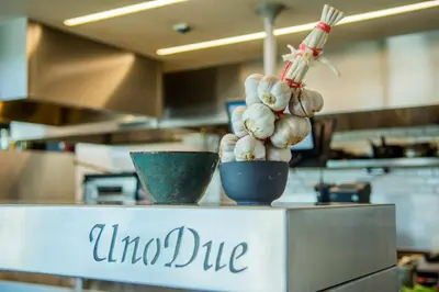a sign in a kitchen with bowls and utensils at Hotel Stayen in Sint-Truiden
