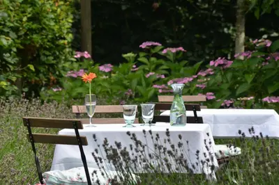 a table with glasses and a vase on it at Boetiekhotel Hemelhuys in Hasselt