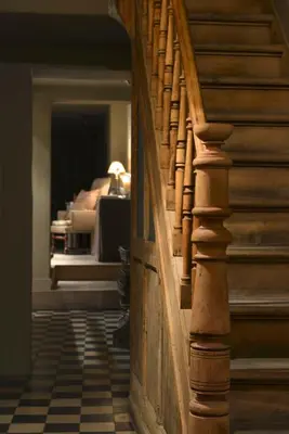 a wooden stairway with a bedroom in the background at Boetiekhotel Hemelhuys in Hasselt