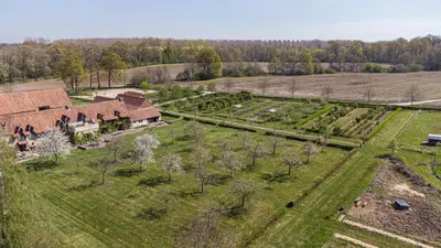 an aerial view of a farmhouse in a field at B&B Kasteelhoeve de Kerckhem in Wijer