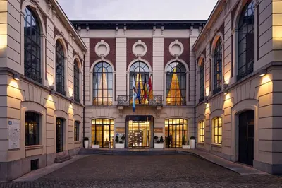 a large building with many windows and lights at Van Der Valk Sélys Liège Hotel & Spa in Liège