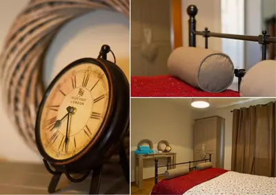 a clock sitting next to a bed in a room at Bosbeekvallei in Opoeteren