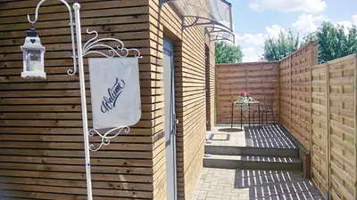 a patio with a sign on the side of a building at La renaissance in Villers-lʼÉvêque