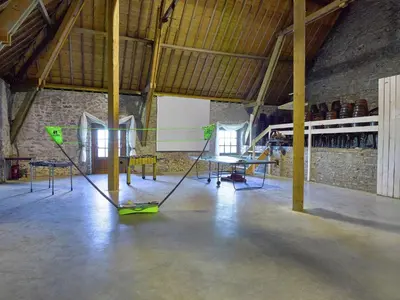 a room with tables and chairs in a building at Limbourg Nature Retreat in Hèvremont
