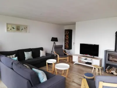 a living room with a couch and a tv at La Balade d'Annie in Trooz
