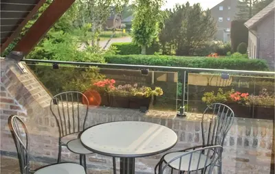 a patio with a table and chairs on a balcony at Holiday Home Kinrooi I in Kinrooi