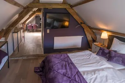 a bedroom with a bed in a attic at de Twie Keuninge in Maasmechelen