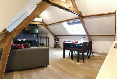 a living room with a couch and a table at de Twie Keuninge in Maasmechelen