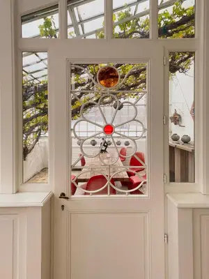 a glass door with a clock on top of it at Château Charles in Pepinster