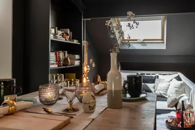 a table with a bottle of wine and candles at Du Coté de chez Jeanne, Suite in Verviers