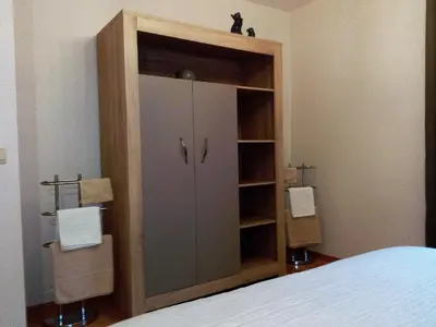 a wooden cabinet with a door in a bedroom at Au Marronnier in Lontzen