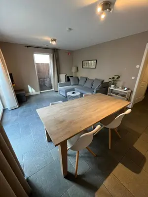 a living room with a wooden table and a couch at Bolderhuys in Bolderberg