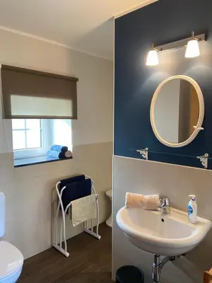 a bathroom with a sink and a mirror at En Vert & En Pause in Thimister