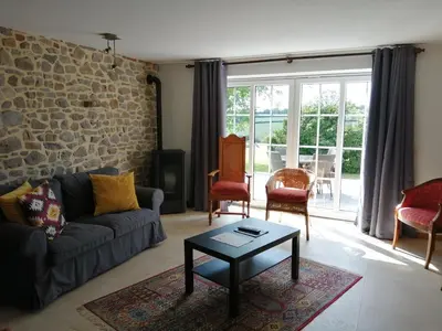 a living room with a couch and a table at En Vert & En Pause in Thimister