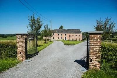 an entrance to an old house with a gate at En Vert & En Pause in Thimister