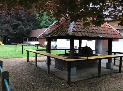 a picnic table with a gazebo in a park at Dortoirs Le Domaine in Bilstain