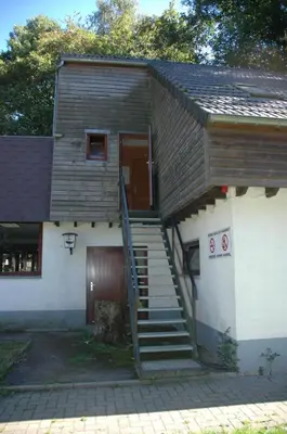 a house with a staircase leading up to a door at Dortoirs Le Domaine in Bilstain