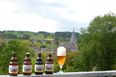 a group of beer bottles and a glass of beer at Hostel De Veurs in Sint-Martens-Voeren