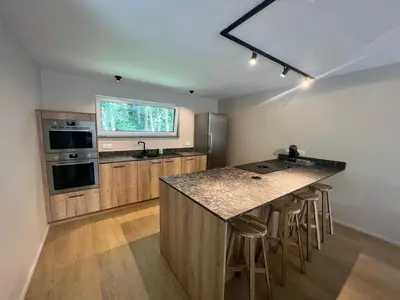 a kitchen with a large island with a counter top at Maison Léon in Bilstain