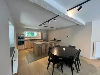 a kitchen and dining room with a table and chairs at Maison Léon in Bilstain