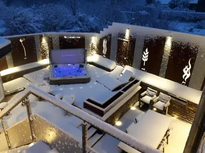 a balcony covered in snow at night at La Renaissance - Deux gites de standing in Herve