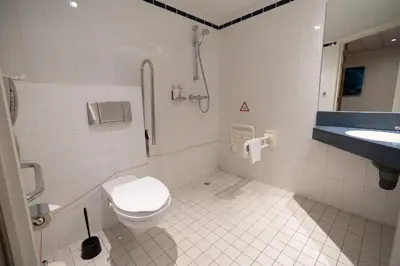 a bathroom with a toilet and a sink at Holiday Inn Express Hasselt by IHG in Hasselt