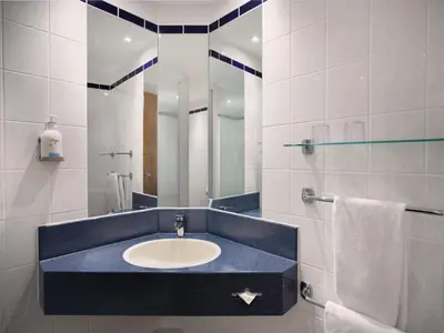 a bathroom with a sink and a mirror at Holiday Inn Express Hasselt by IHG in Hasselt