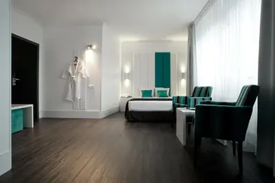 a hotel room with a bed and a table and chairs at Hotel Ecu in Genk