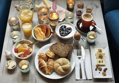 a table topped with plates of breakfast foods and drinks at Hotel Ecu in Genk