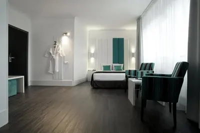 a hotel room with a bed and a table and chairs at Hotel Ecu in Genk